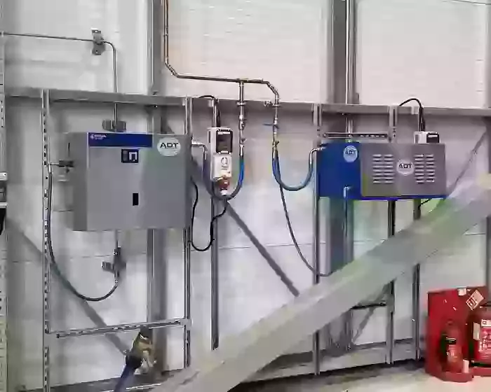 Nilfisk SC Uno and DTE pressure washers mounted on UniStrut framing at a logistics facility in Ellistown.